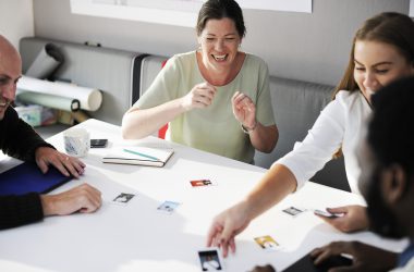 Employees busy looking and arranging colleague photos.